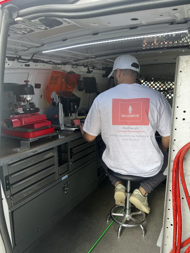 Gadi cutting a key inside the van